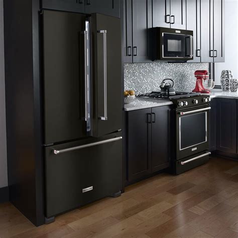 black stainless steel appliances with gray cabinets|black fridge in white kitchen.